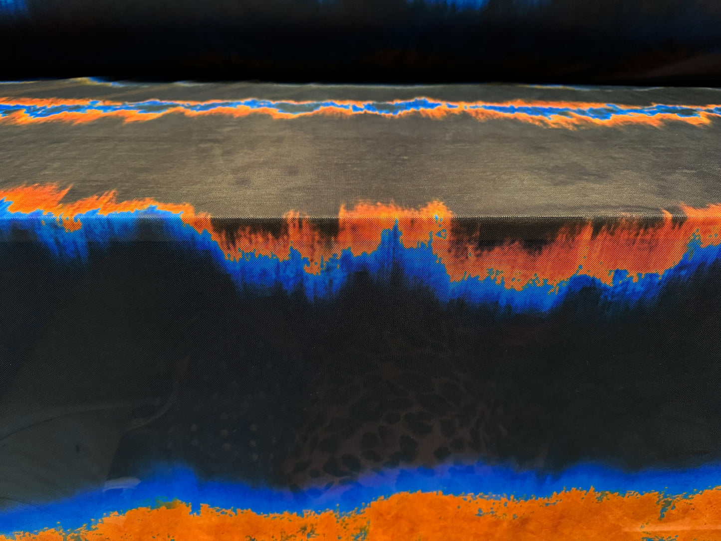 Power mesh net stretch spandex fabric, per metre - ombré volcano print - black orange & blue
