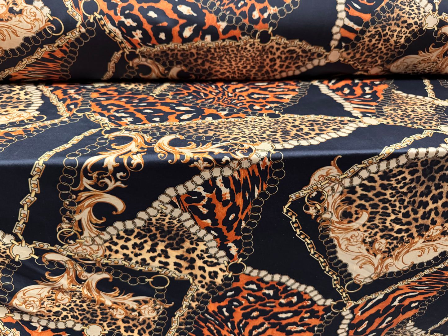 Soft touch stretch spandex single jersey fabric, per metre - leopard and chains print - black gold & orange