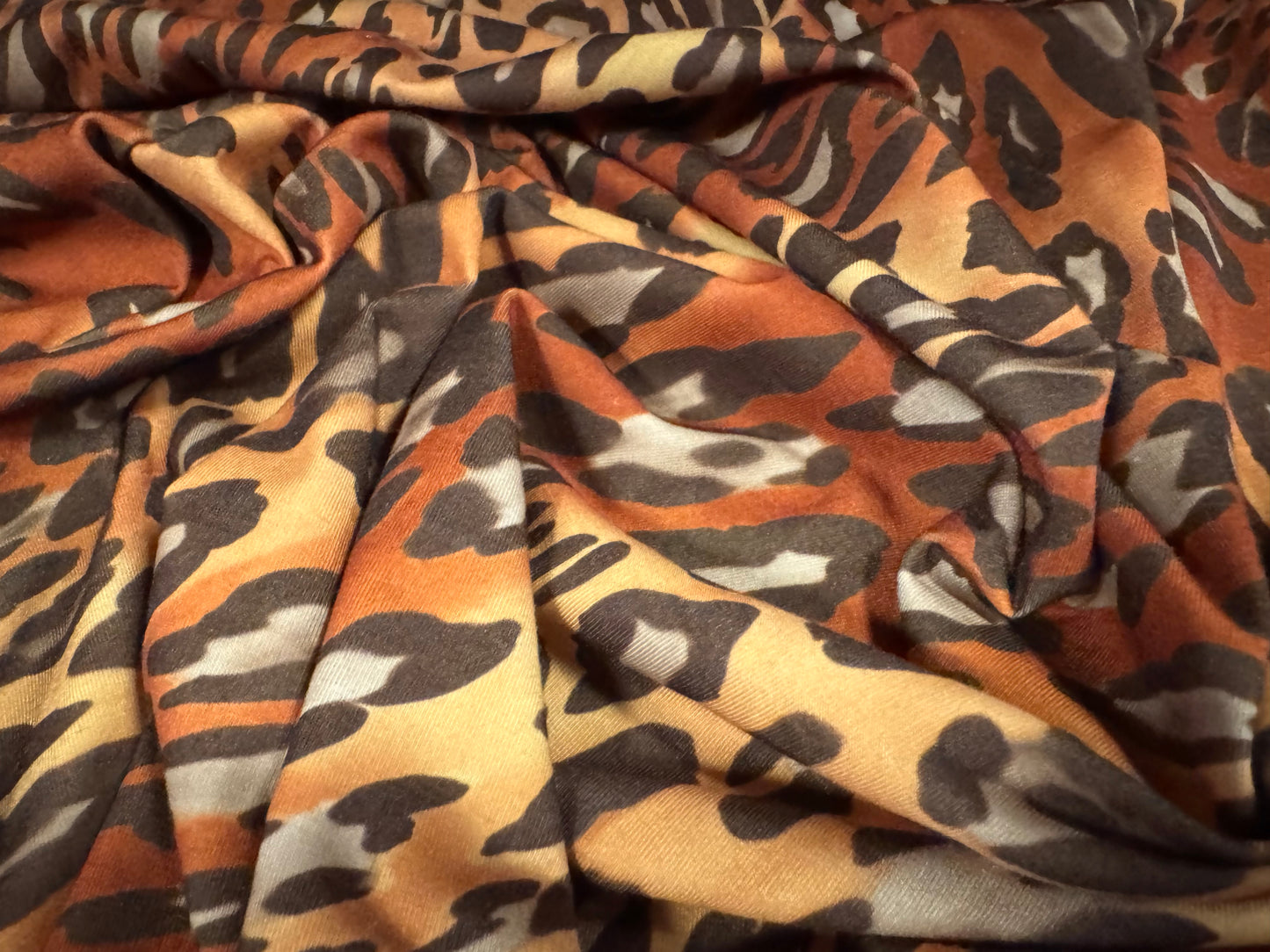 Stretch spandex interlock jersey fabric, per metre - animal swirl print - brown & honey