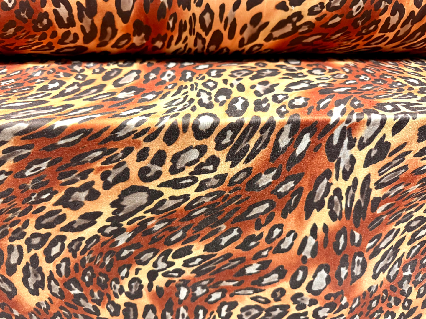 Stretch spandex interlock jersey fabric, per metre - animal swirl print - brown & honey