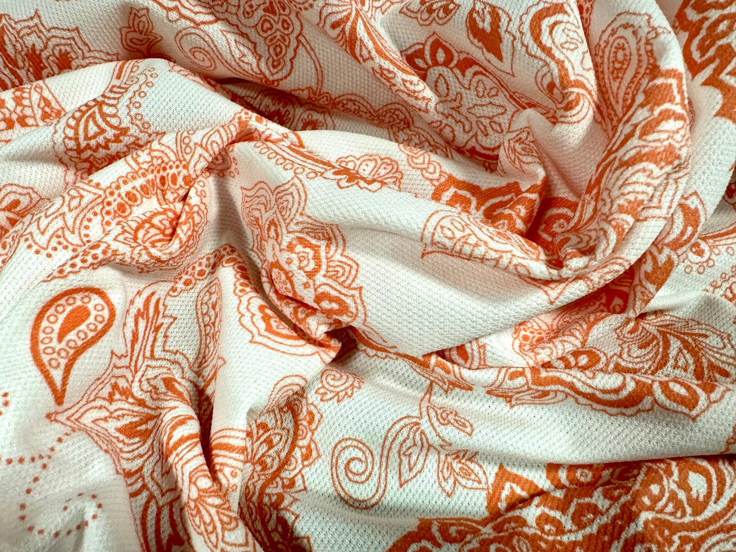 Pique textured jersey fabric, per metre - paisley print - orange & white