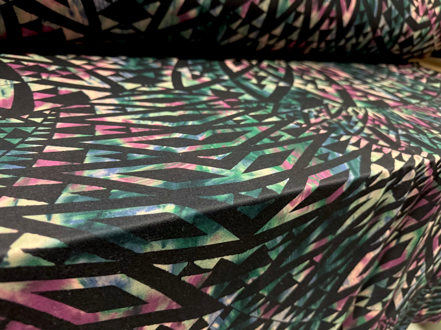 Valentino scuba style stretch jersey fabric, per metre - geometric tribal swirl print - dark emerald green, black & pink