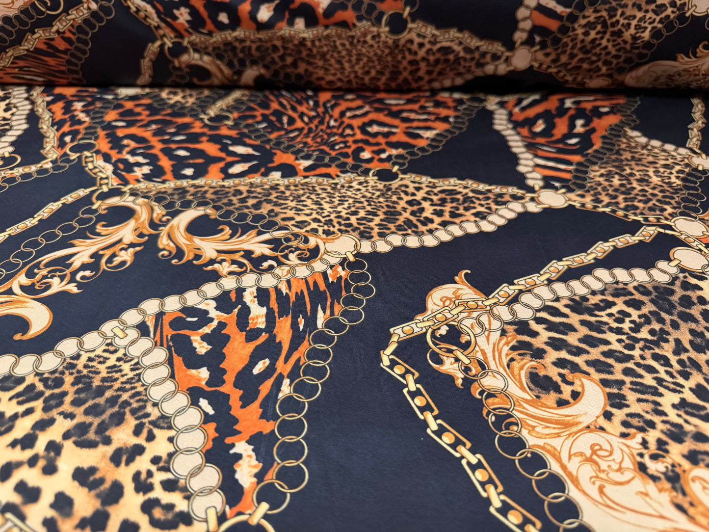 Soft touch stretch spandex single jersey fabric, per metre - leopard and chains print - black gold & orange