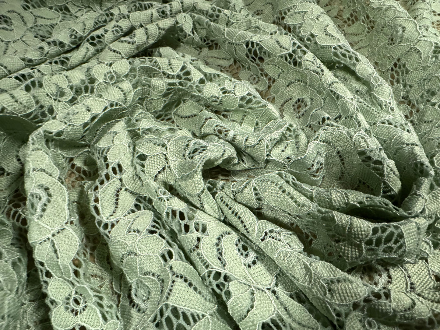 Corded stretch lace fabric, per metre - scalloped selvedge - floral - sage green