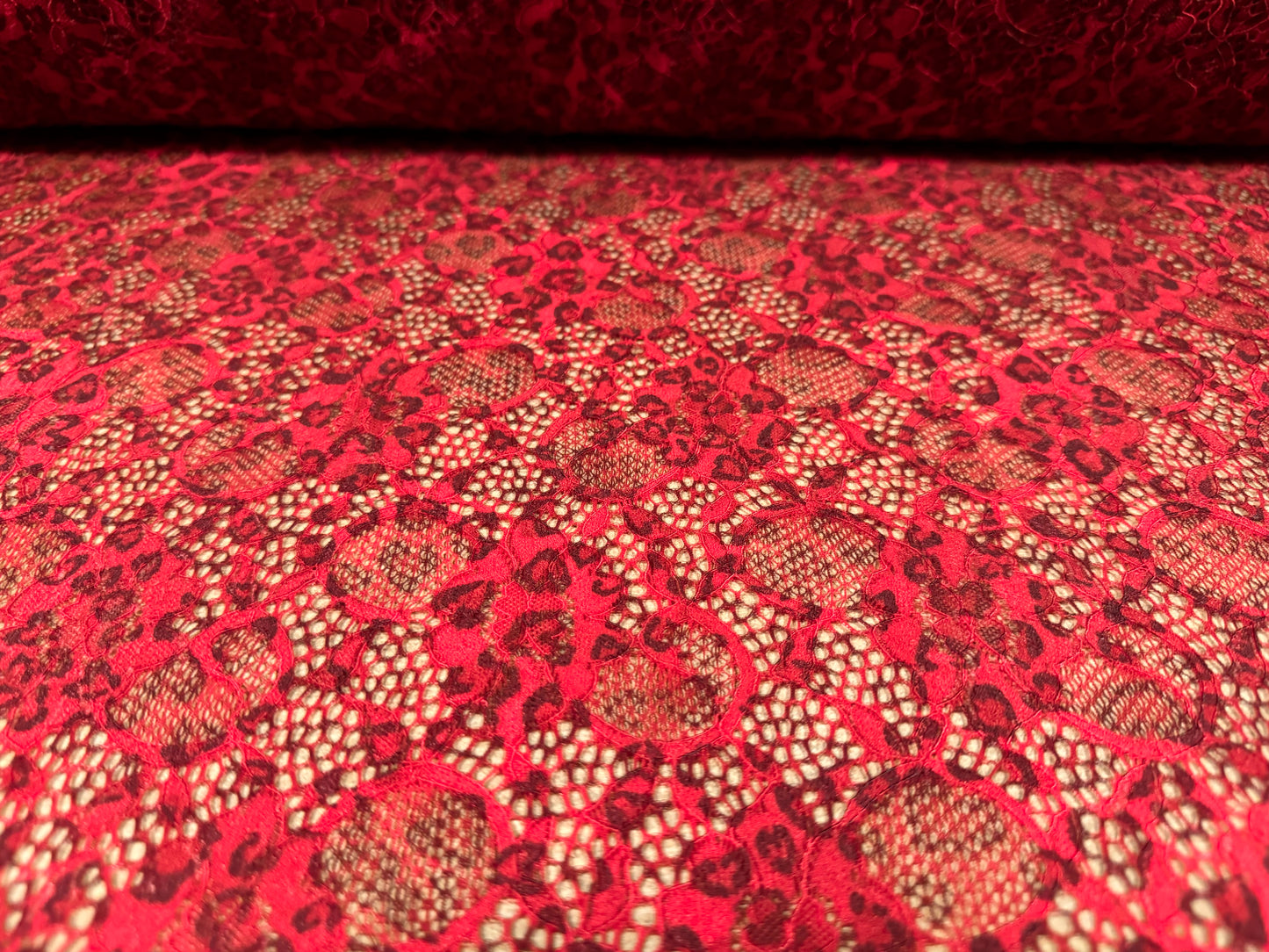 Stretch lace dress fabric with scalloped selvedge, per metre - animal print - red & black