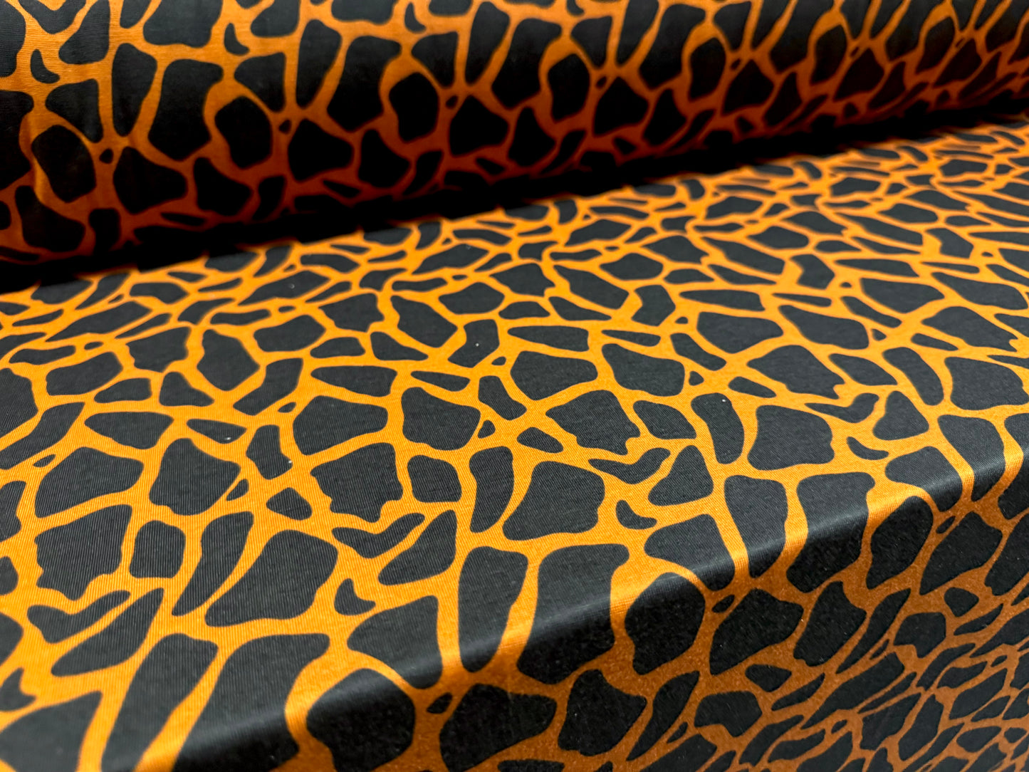 Soft handle single jersey fashion fabric, per metre - giraffe animal print - orange & black