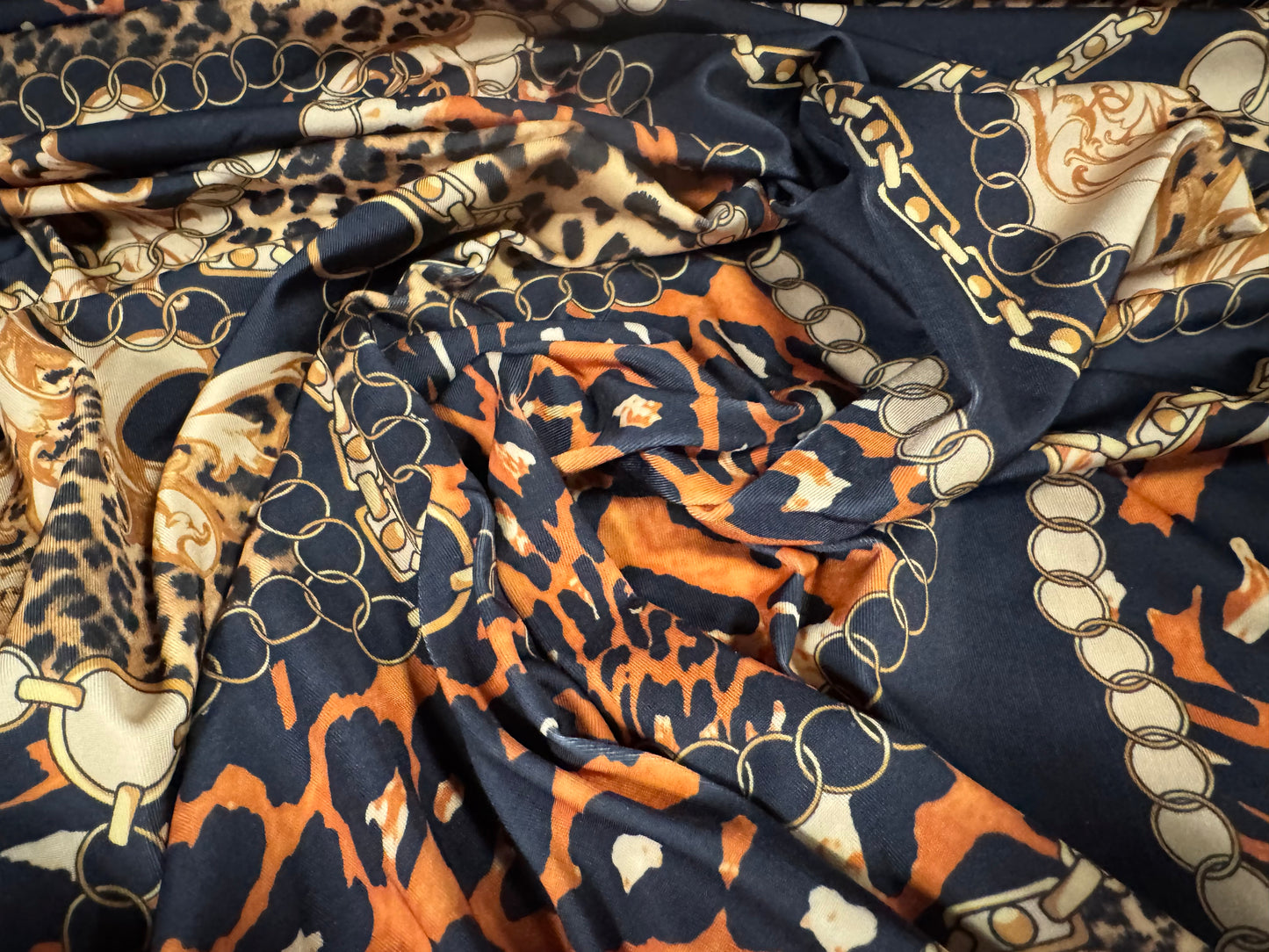 Soft touch stretch spandex single jersey fabric, per metre - leopard and chains print - black gold & orange