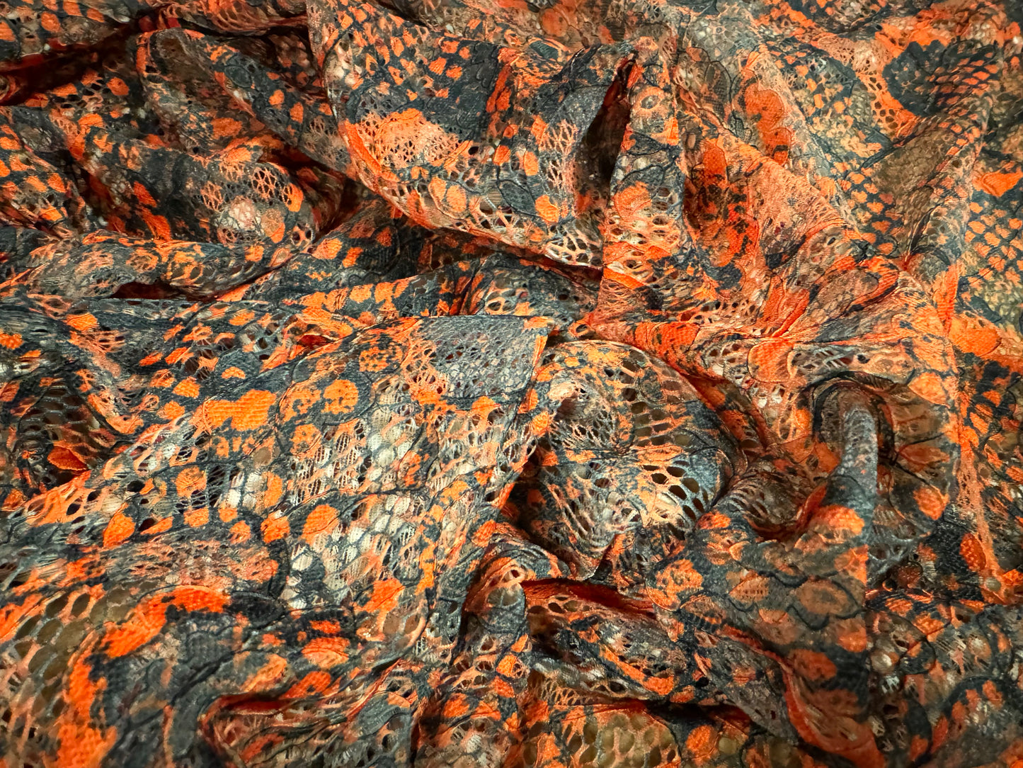 Stretch lace dress fabric with scalloped selvedge, per metre - distressed snakeskin print - burnt orange