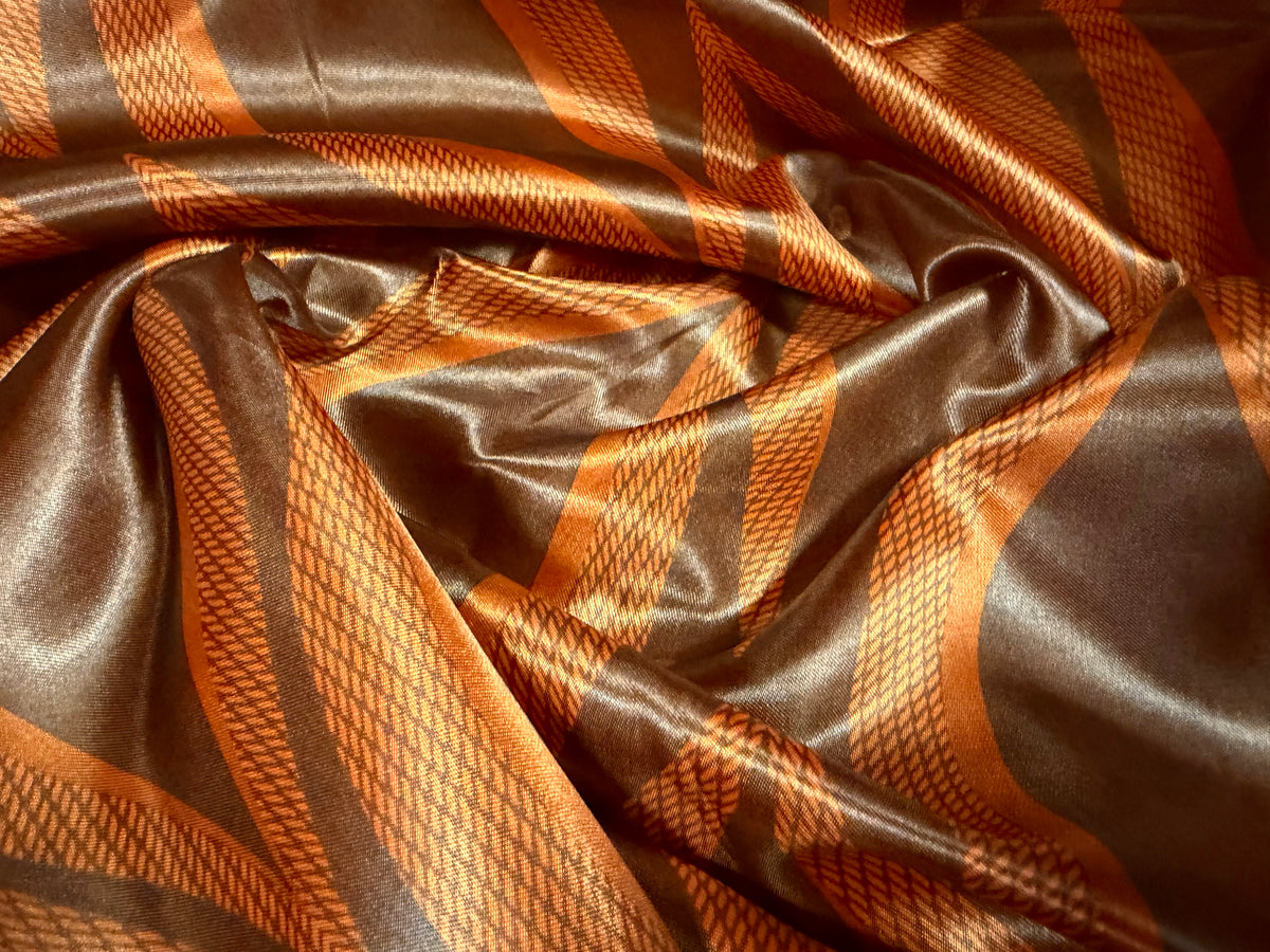 Satin woven dress fabric, per metre - teardrop print - orange & copper