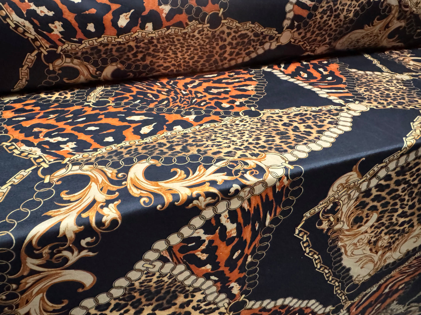 Soft touch stretch spandex single jersey fabric, per metre - leopard and chains print - black gold & orange