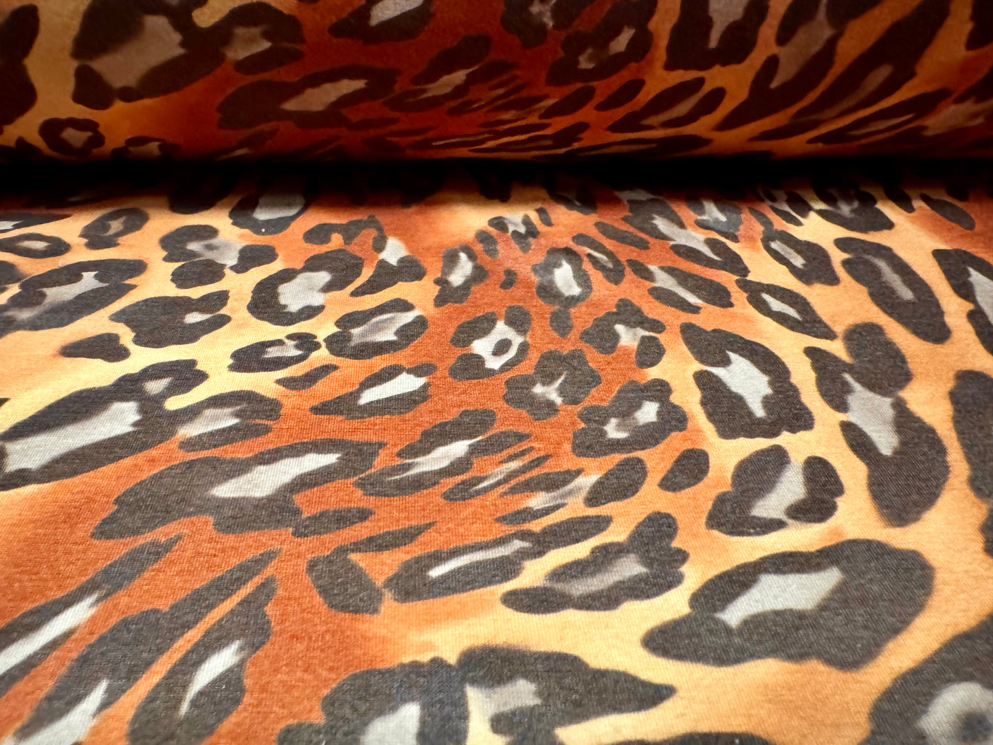 Stretch spandex interlock jersey fabric, per metre - animal swirl print - brown & honey