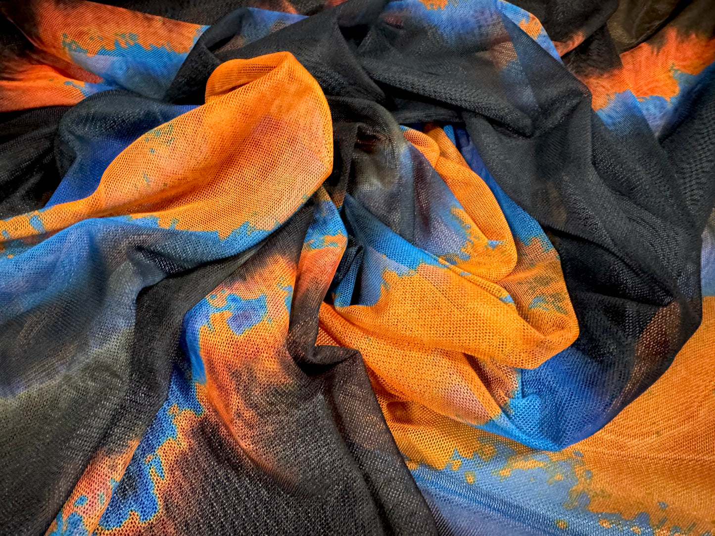 Power mesh net stretch spandex fabric, per metre - ombré volcano print - black orange & blue