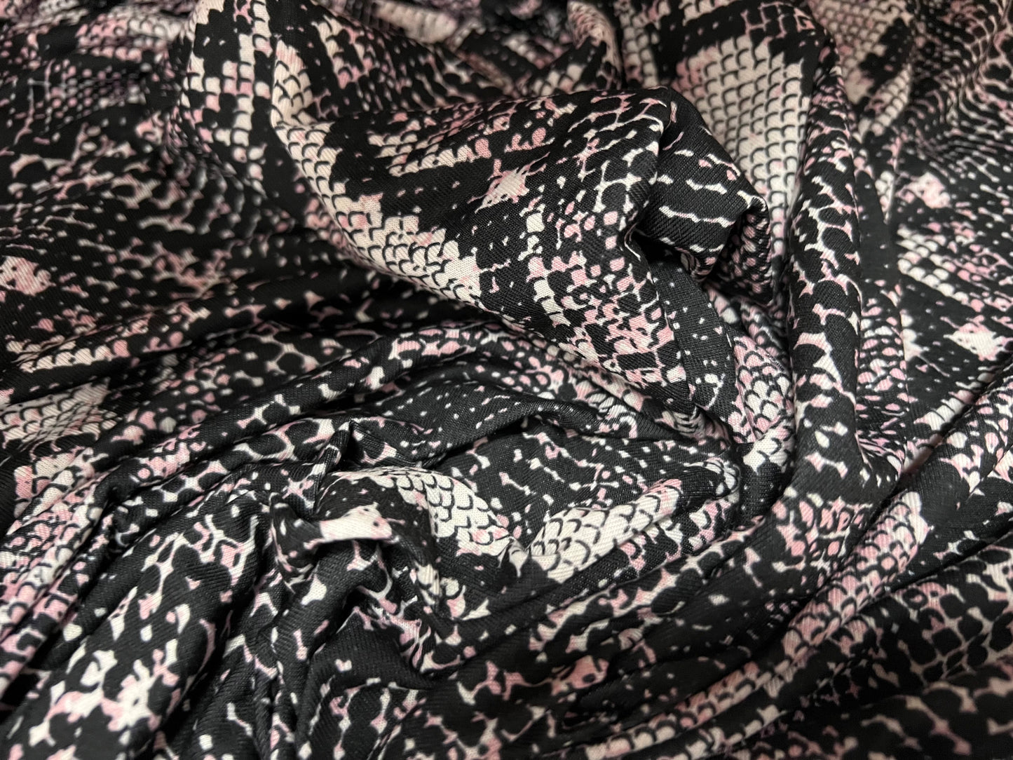 Soft handle stretch single jersey fabric, per metre - snakeskin animal print - black & pink
