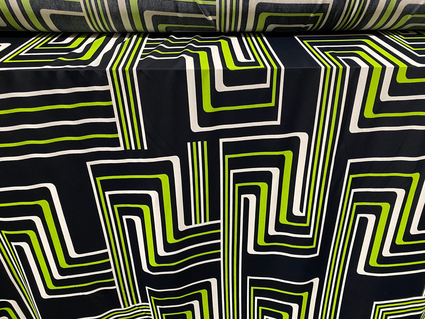 Spandex stretch ITY jersey fabric, per metre - black with black & green retro geometric print