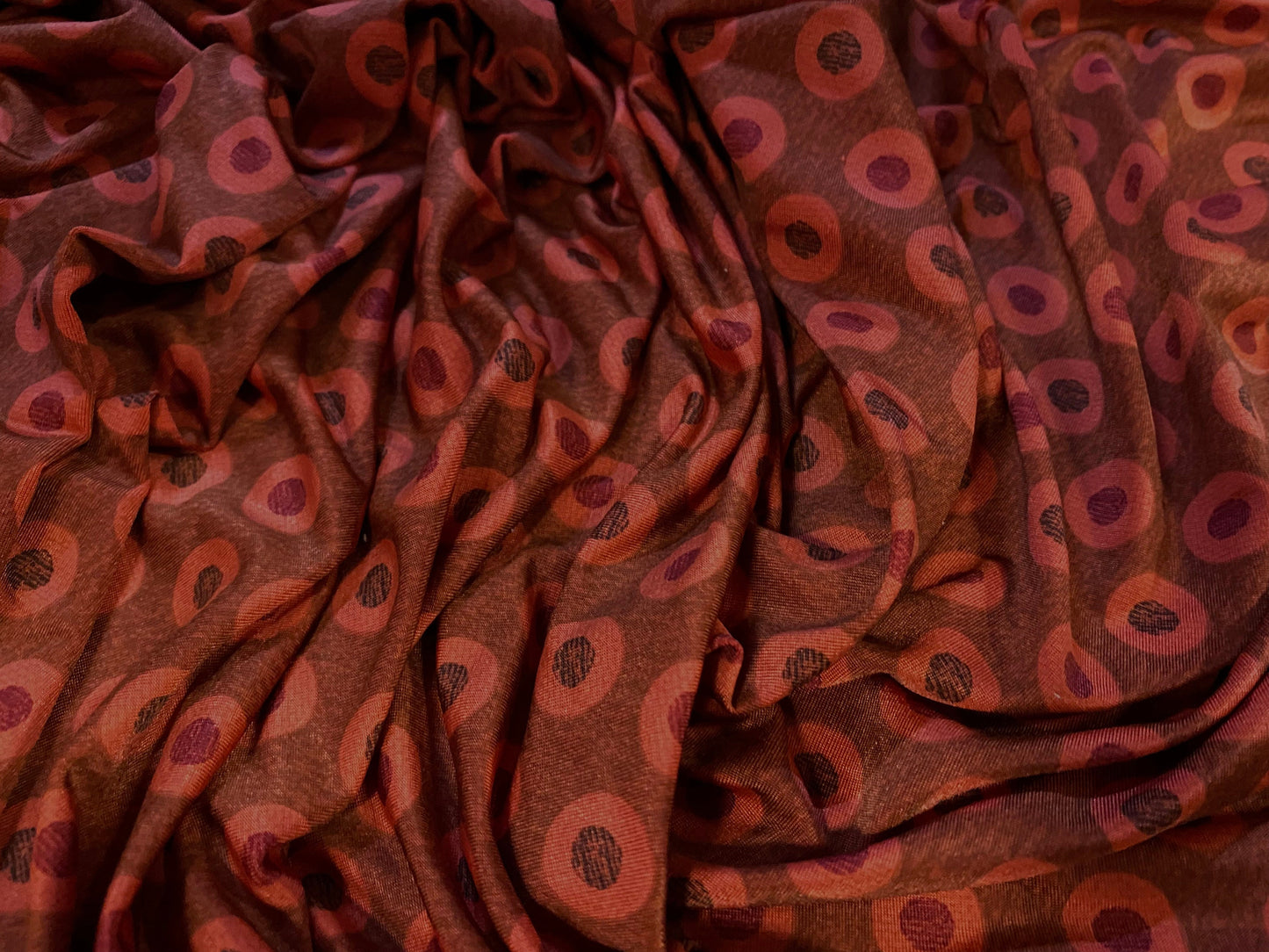 Disco shimmer stretch jersey fabric, per metre - circles print - burnt Orange