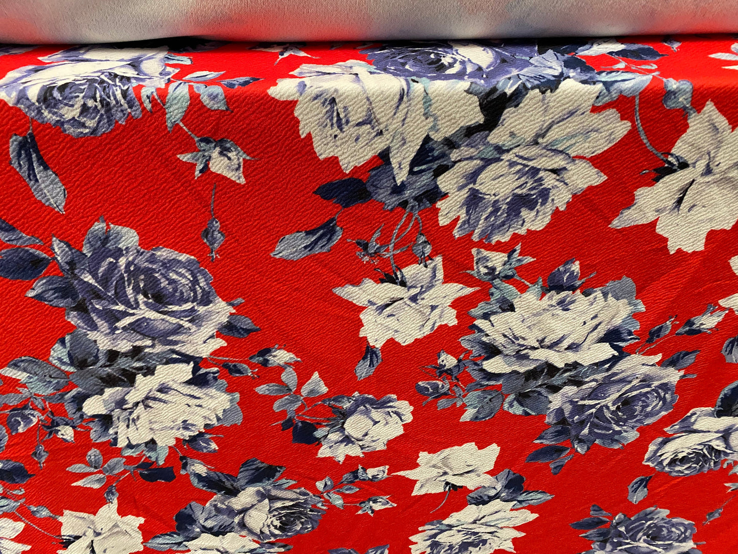 Scuba textured ‘Liverpool’ stretch spandex jersey fabric, per metre - Red with blue rose print