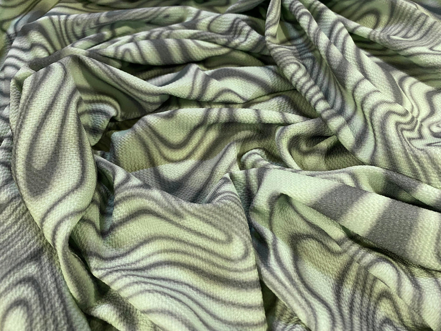 Bubble crepe woven dress fabric with comfort stretch - psychedelic swirl print - green khaki
