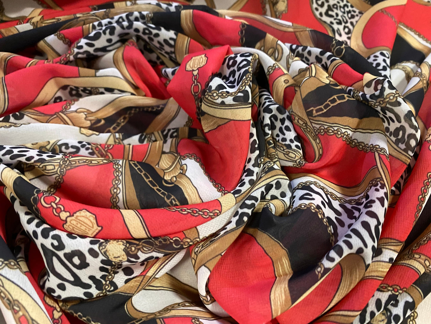 Printed chiffon dress blouse fabric, per metre - designer buckles and chains print - red gold & black