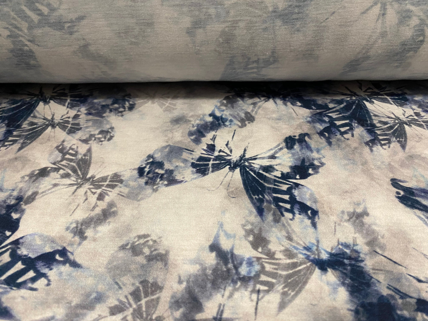 Soft handle stretch jersey fabric, per metre - distressed butterfly print - Petrol blue grey