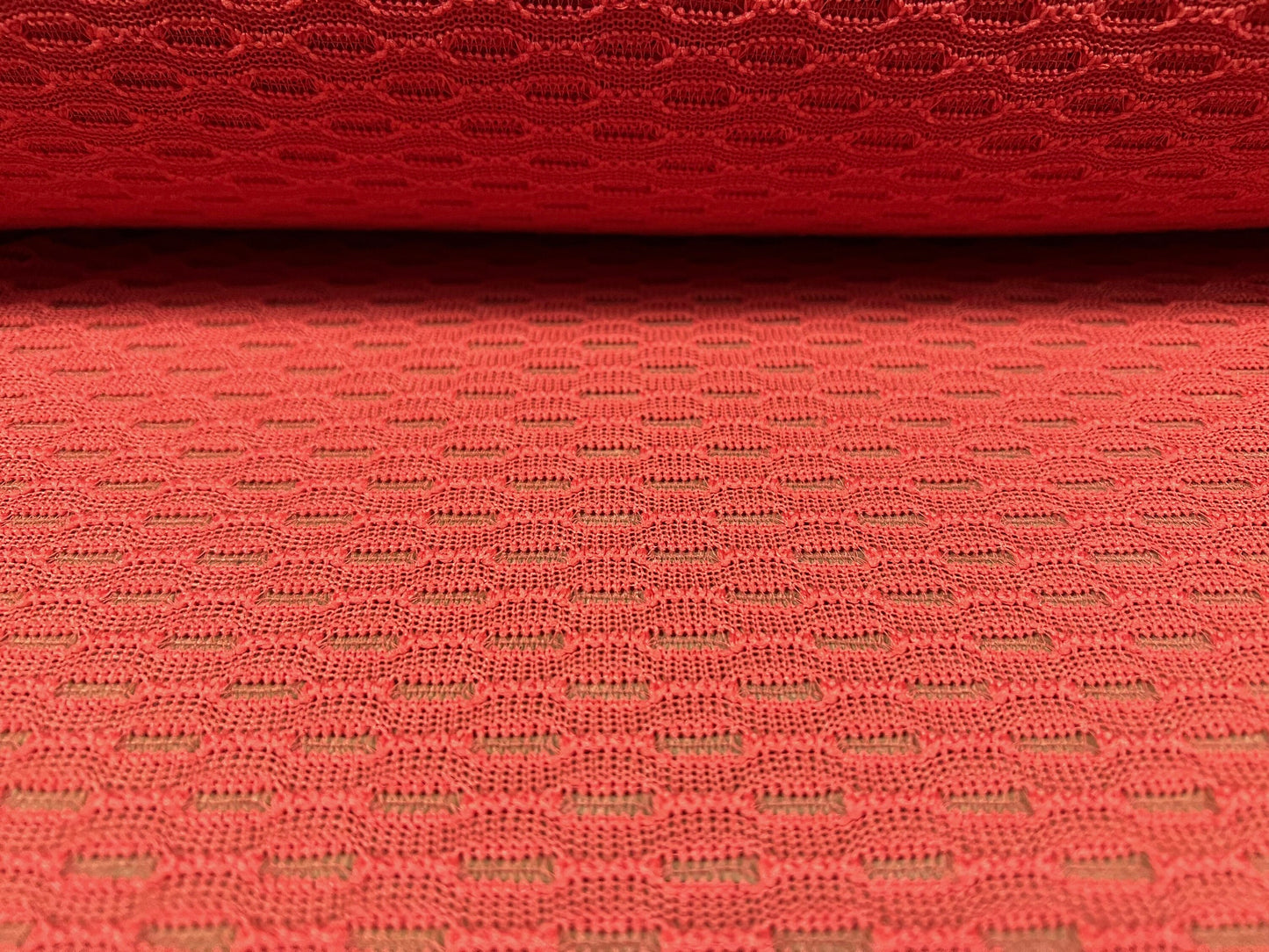 Eyelet jacquard knitwear jersey dress fabric, per metre - geometric design - coral