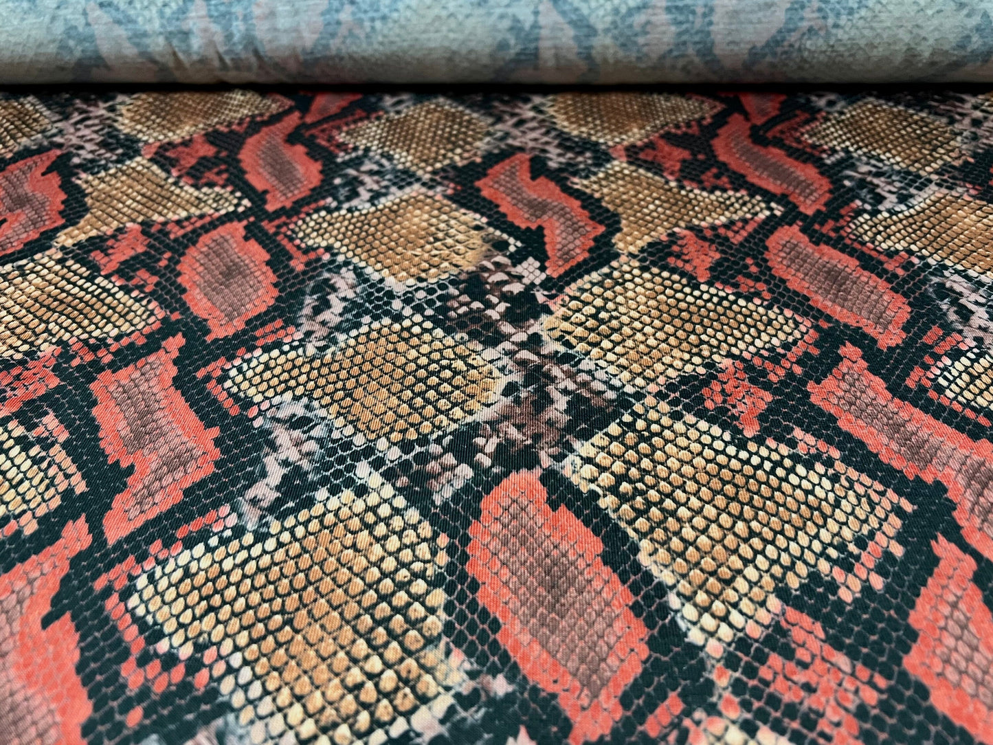 Soft handle stretch spandex single jersey fabric, per metre - snakeskin animal print - orange & red