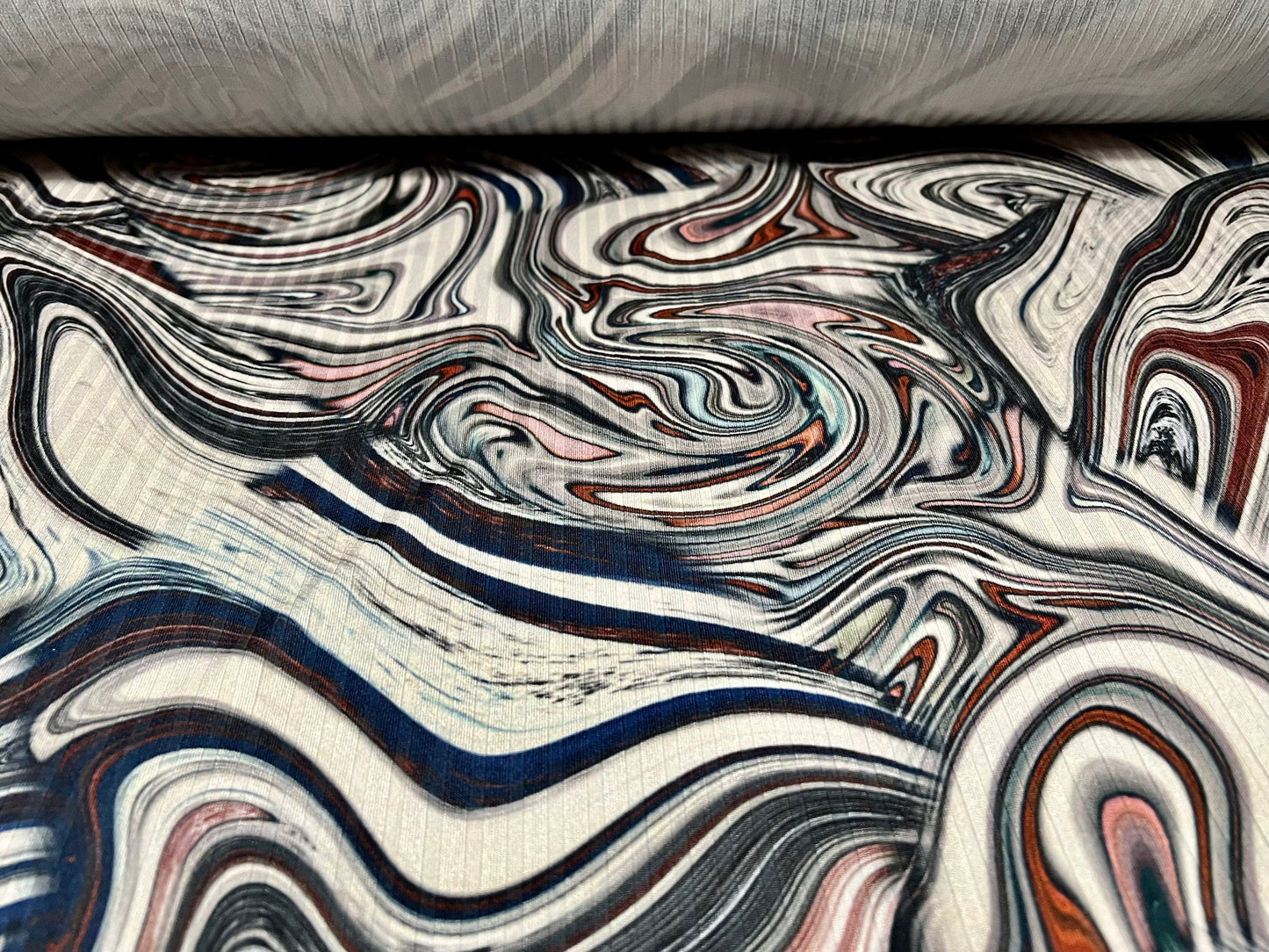 Stretch spandex rib jersey fabric, per metre - swirl print - cream navy orange