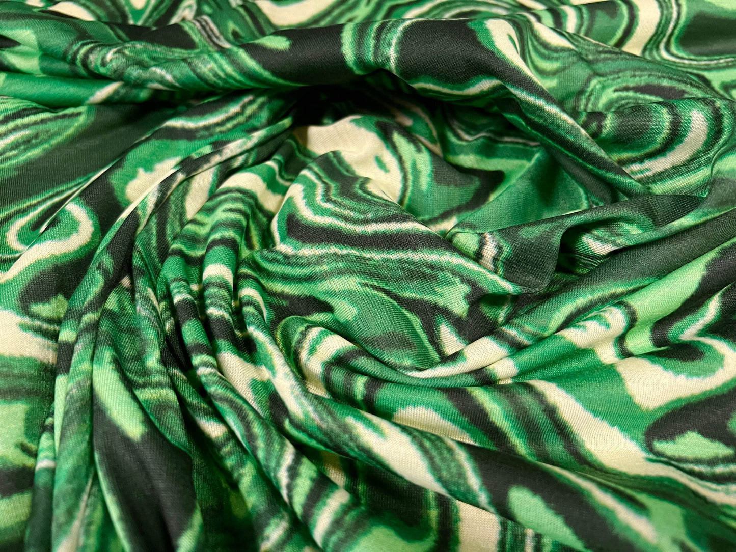 Soft handle single jersey dress fabric, per metre - Retro swirl print - green & cream