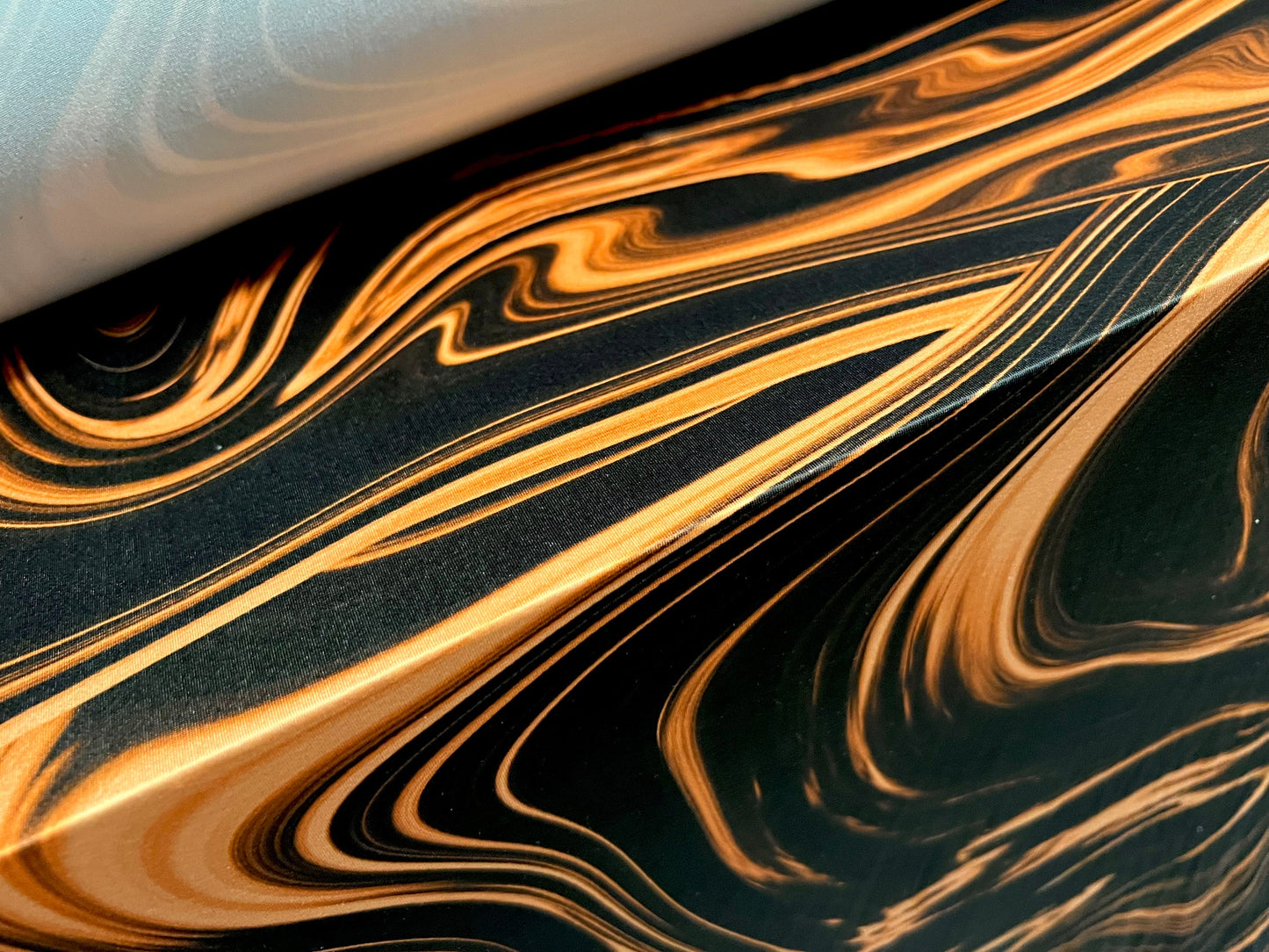 Soft touch stretch spandex jersey fabric, per metre - Swirl print - black & orange