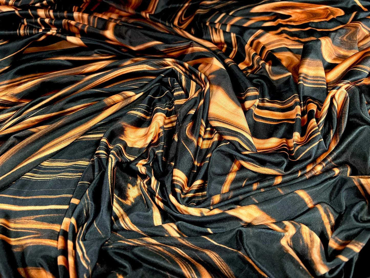 Soft touch stretch spandex jersey fabric, per metre - Swirl print - black & orange