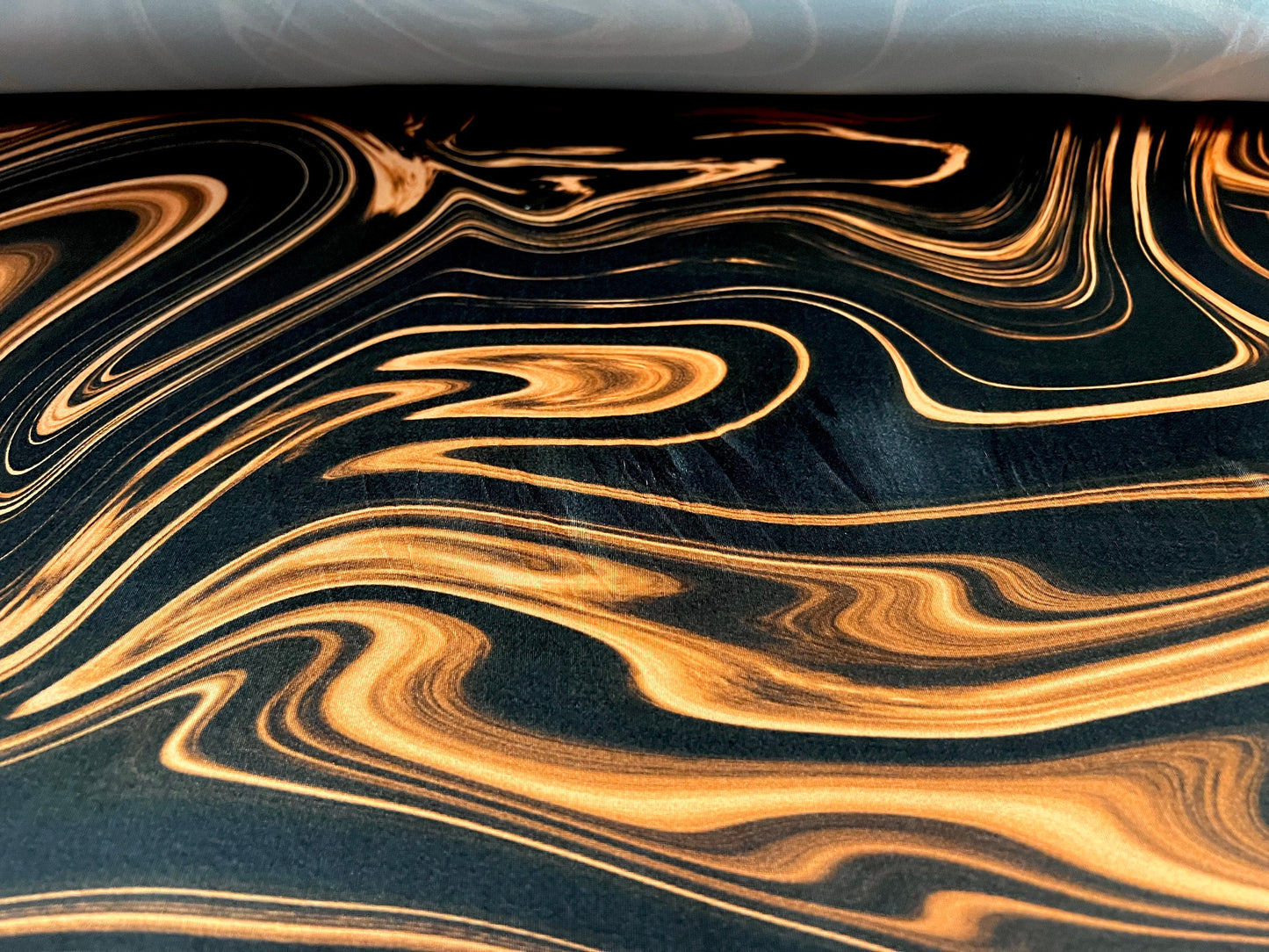 Soft touch stretch spandex jersey fabric, per metre - Swirl print - black & orange