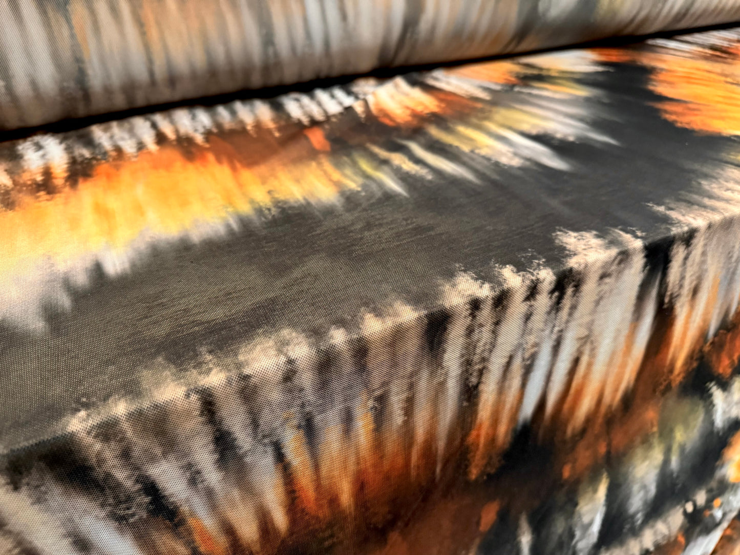Power mesh net stretch spandex fabric, per metre - tie dye streak print - black orange and cream