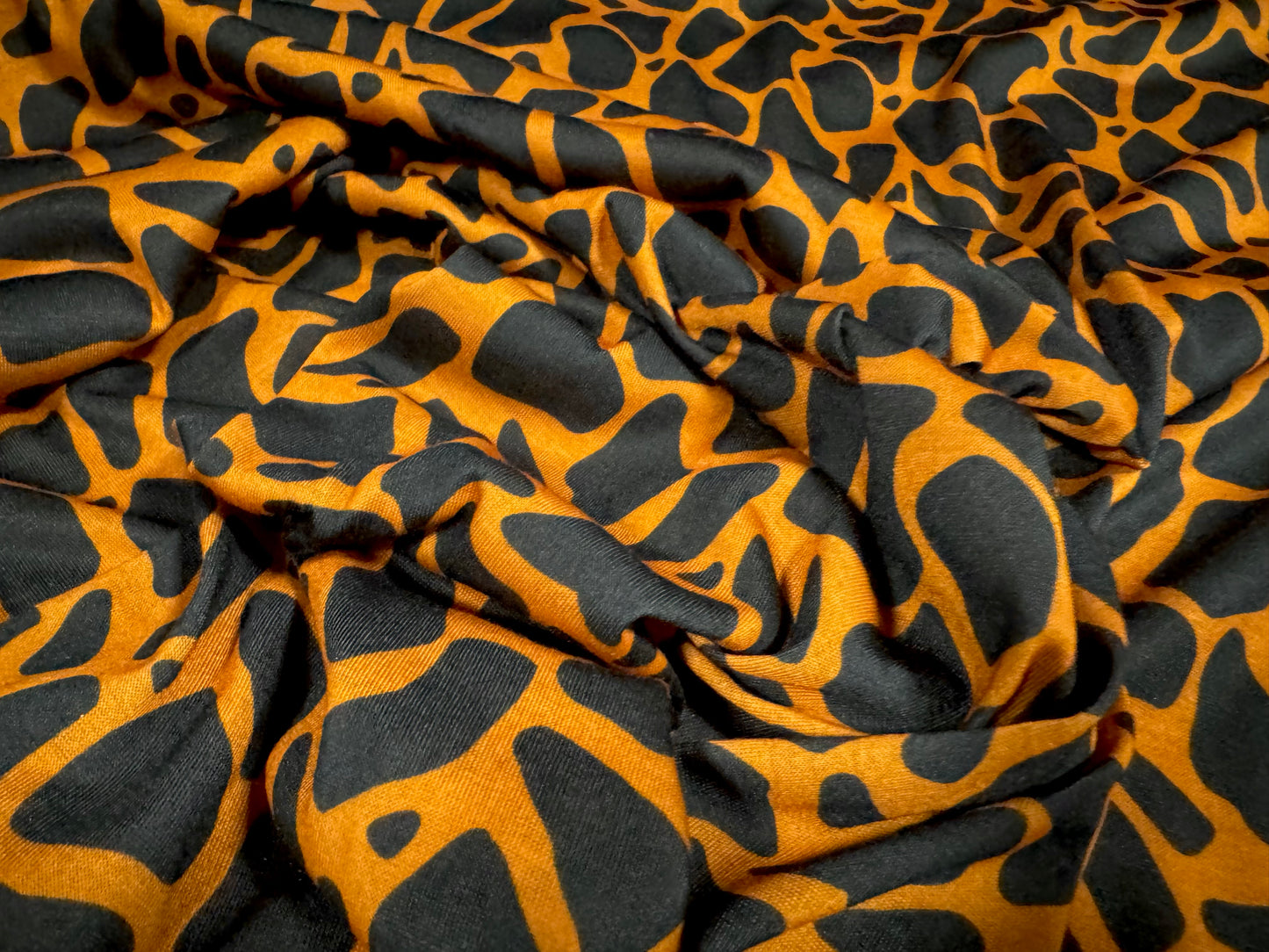 Soft handle single jersey fashion fabric, per metre - giraffe animal print - orange & black