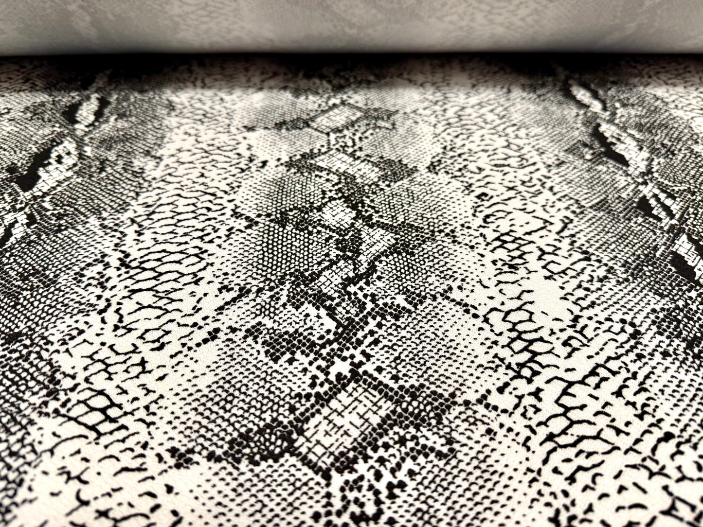 Waterfall textured scuba stretch double jersey fabric, per metre - snake skin print - black & ivory