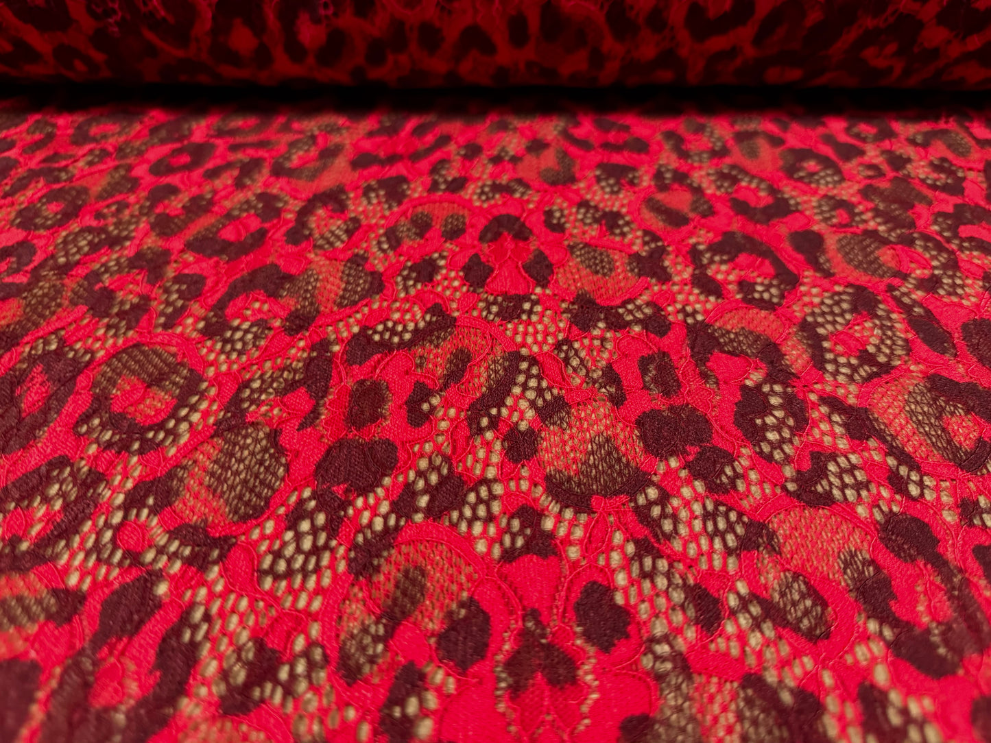 Stretch lace dress fabric with scalloped selvedge, per metre - cheetah animal print - red & brown