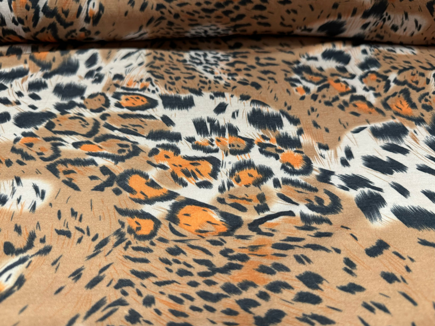 Soft handle stretch single jersey fashion fabric, per metre - stylised animal print - beige & orange