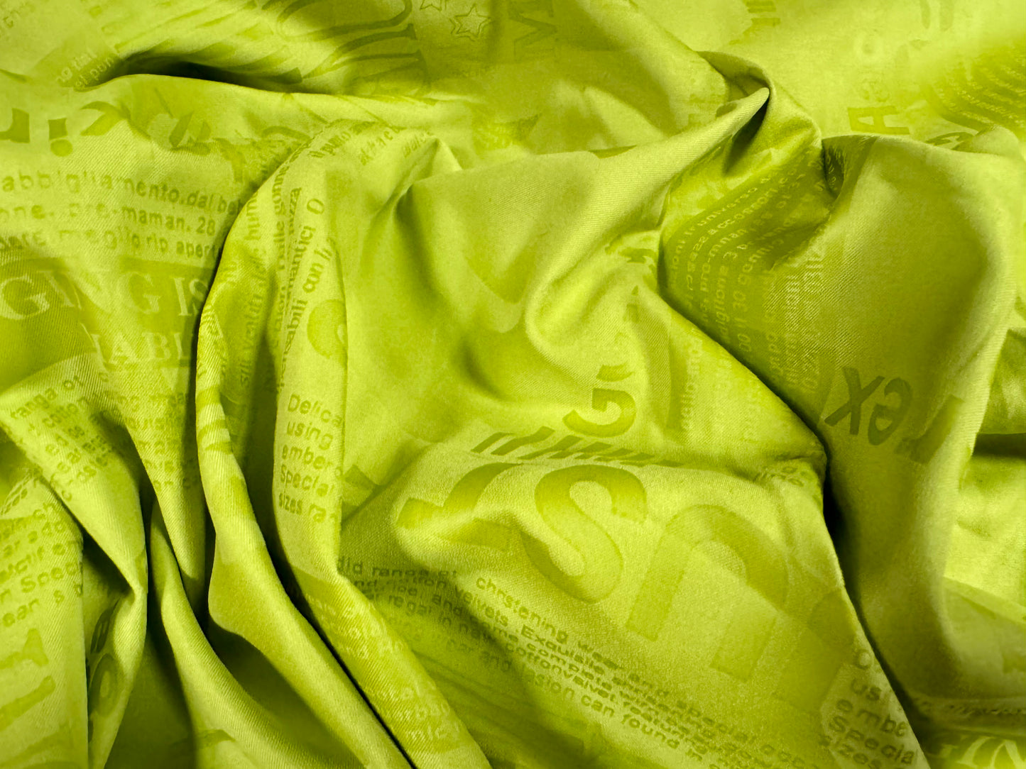 Woven powder touch fashion fabric, per metre - embossed words & letters print - Apple green