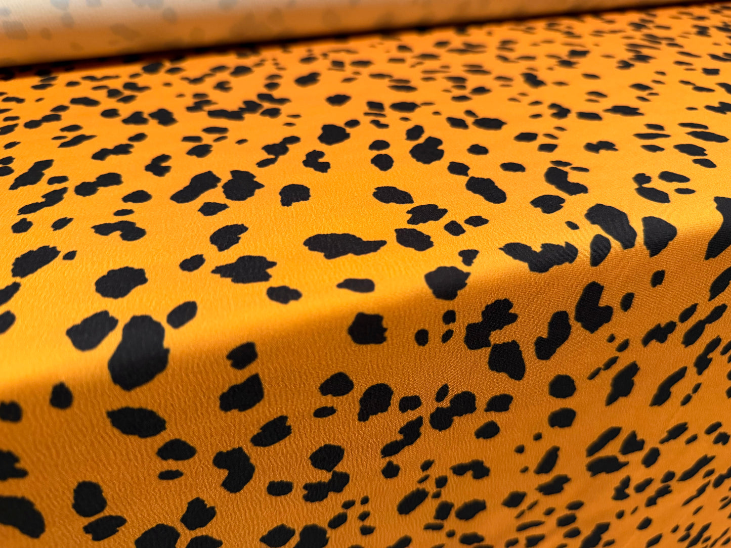 Sateen back crepe woven fashion fabric, per metre - Dalmatian print - honey