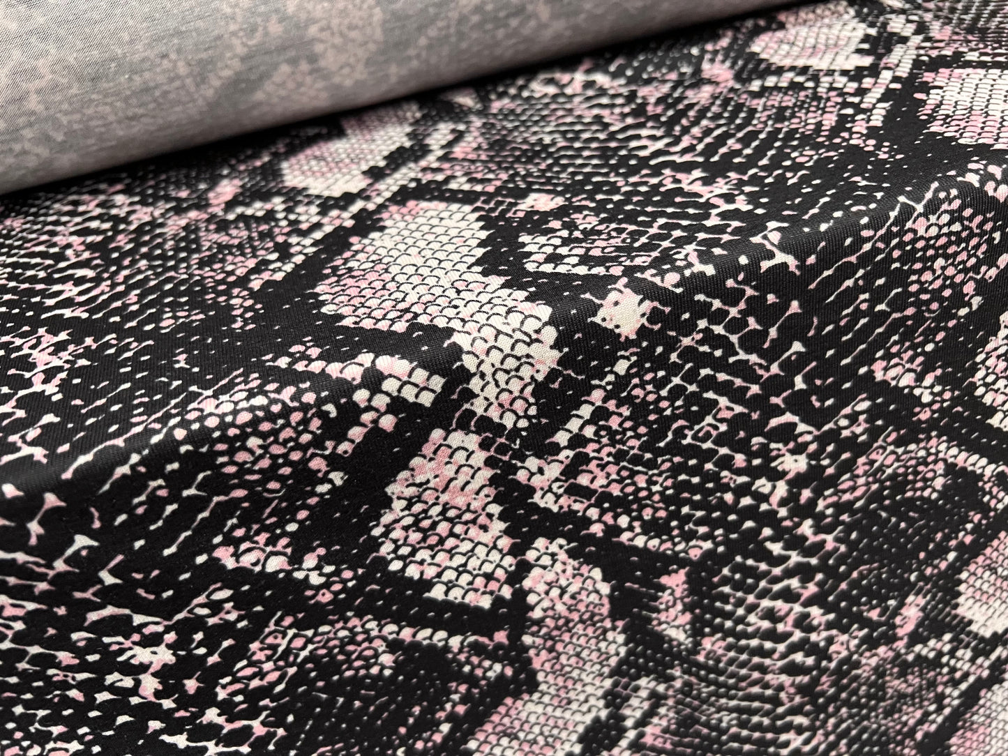 Soft handle stretch single jersey fabric, per metre - snakeskin animal print - black & pink