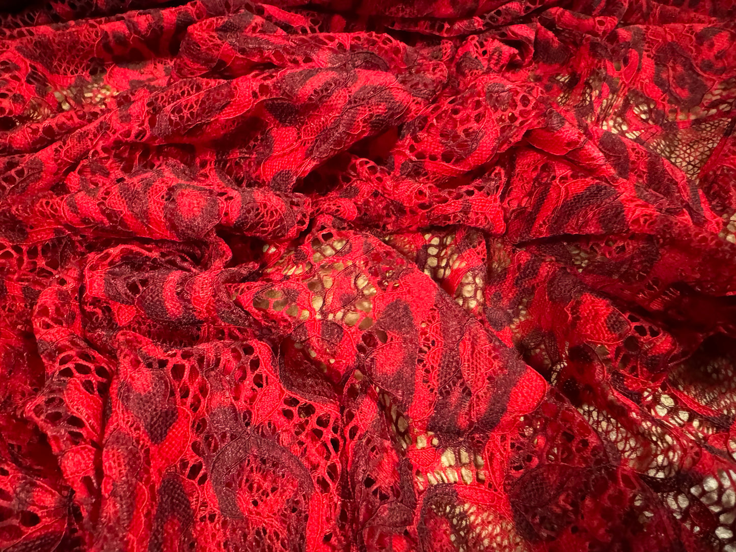 Stretch lace dress fabric with scalloped selvedge, per metre - distressed animal print - red & maroon