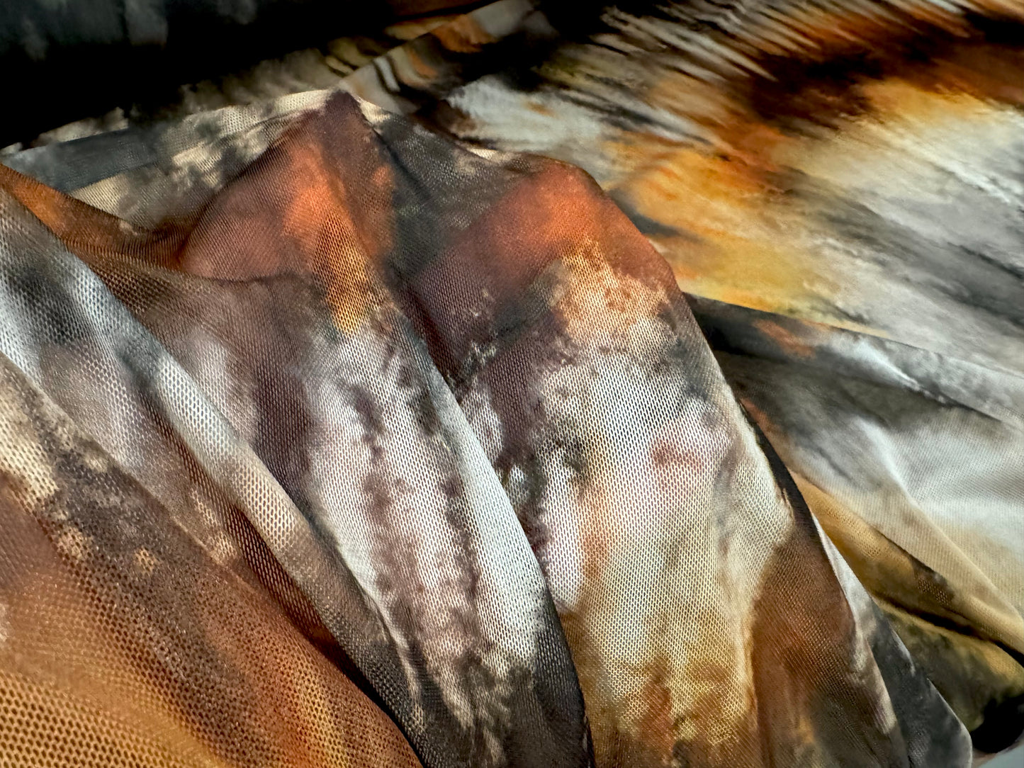Power mesh net stretch spandex fabric, per metre - tie dye streak print - black orange and cream