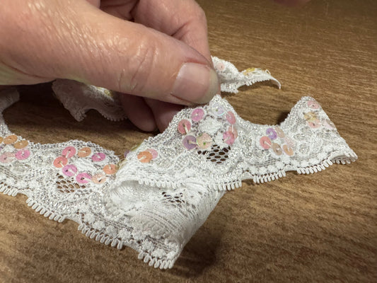 Scalloped lace edging trim fabric with sequins - stretch - paper white, pink & lilac