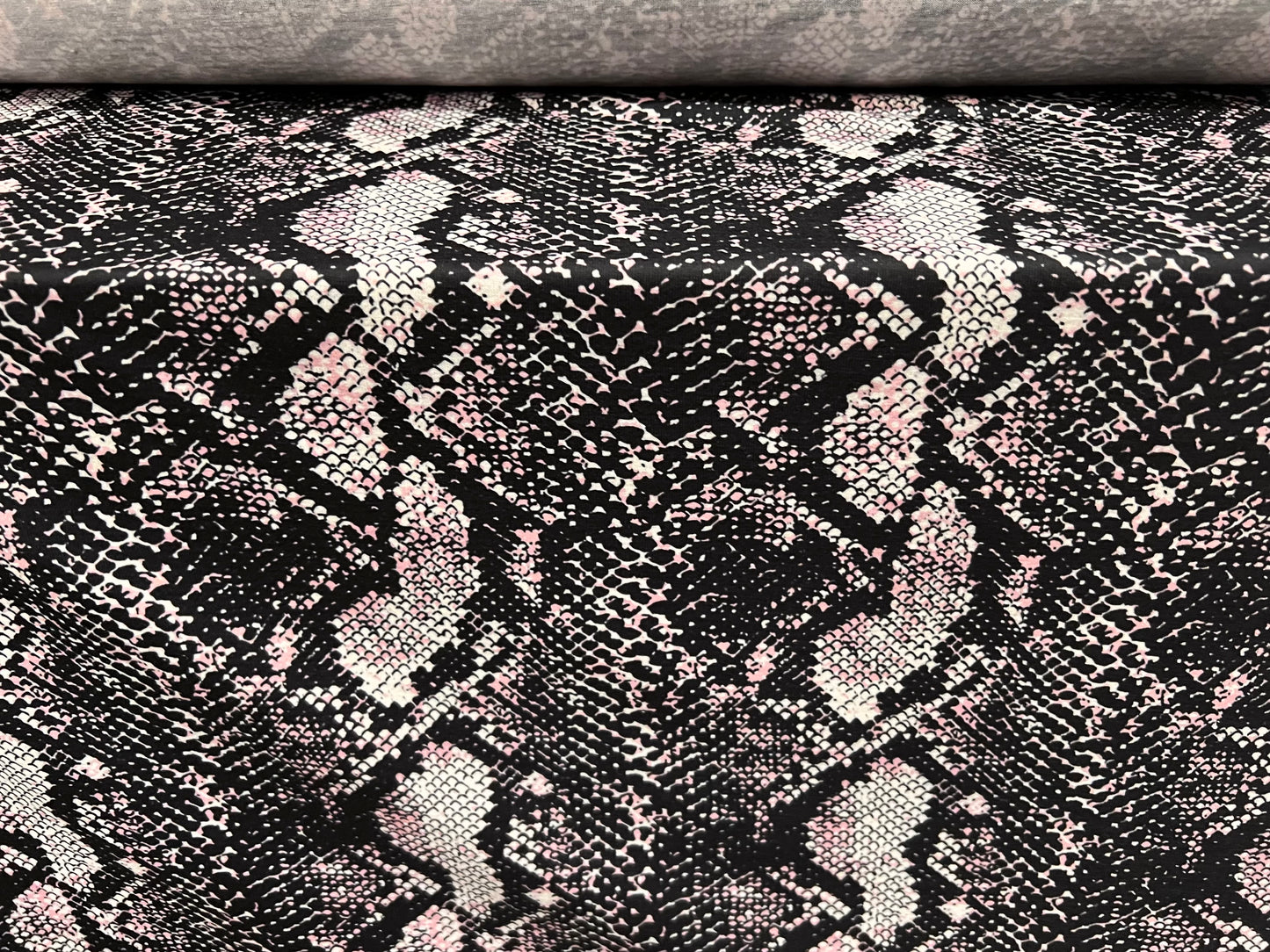 Soft handle stretch single jersey fabric, per metre - snakeskin animal print - black & pink