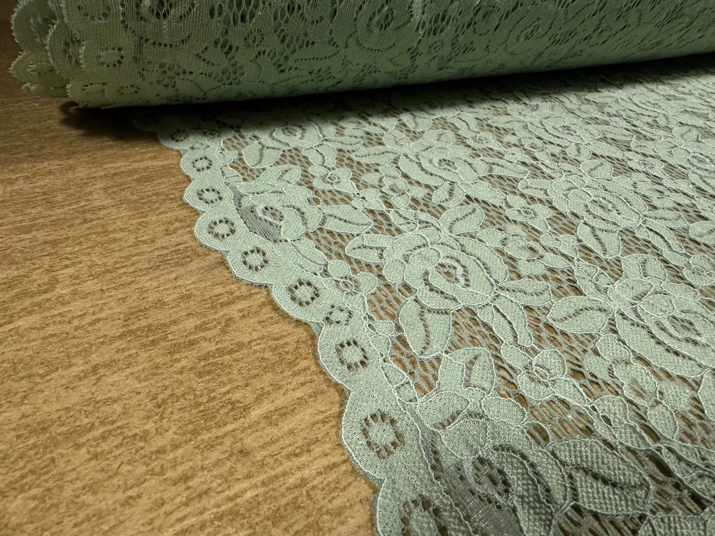 Corded stretch lace fabric, per metre - scalloped selvedge - floral - sage green