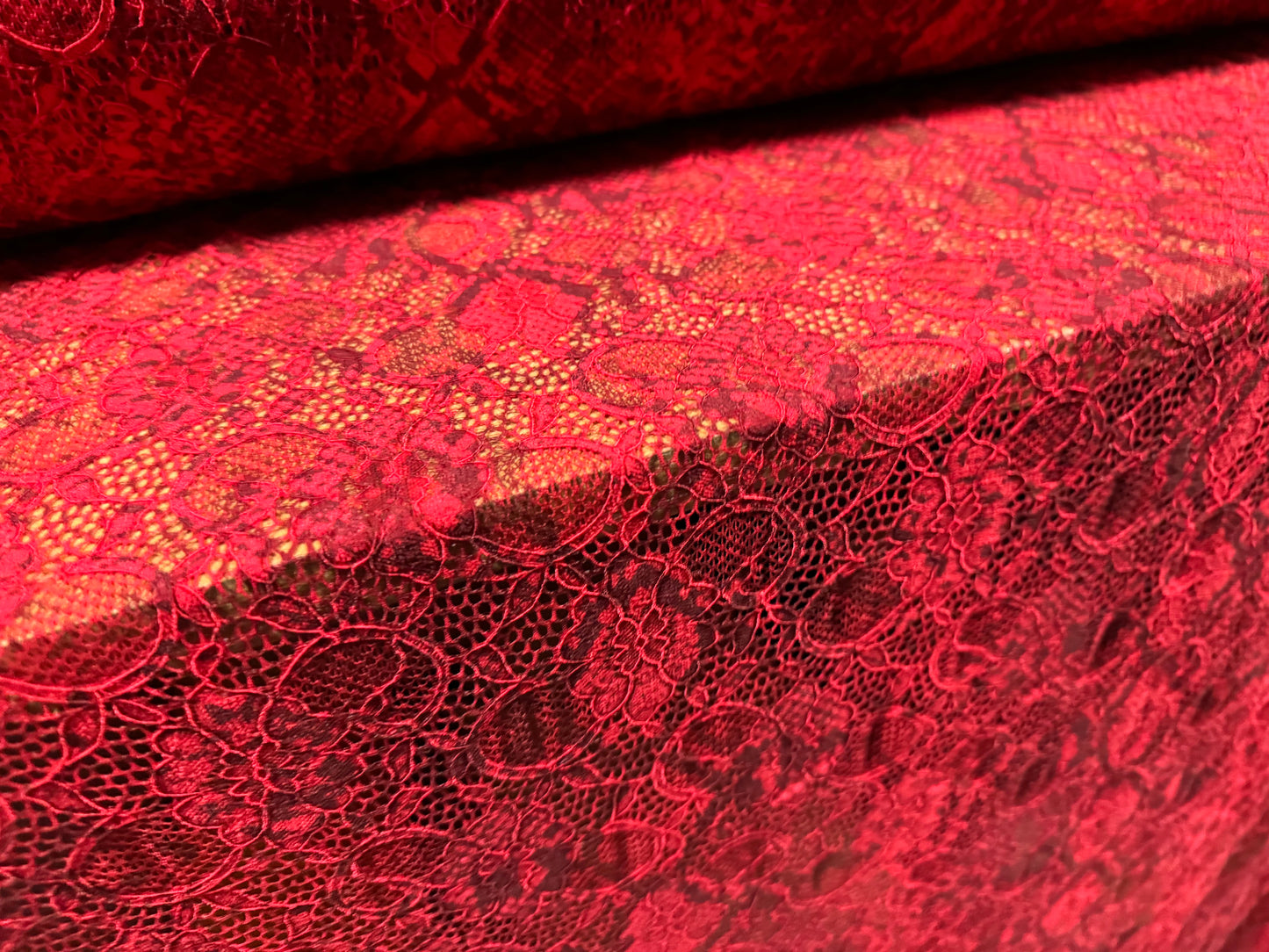 Stretch lace dress fabric with scalloped selvedge, per metre - snakeskin animal print - red & grey