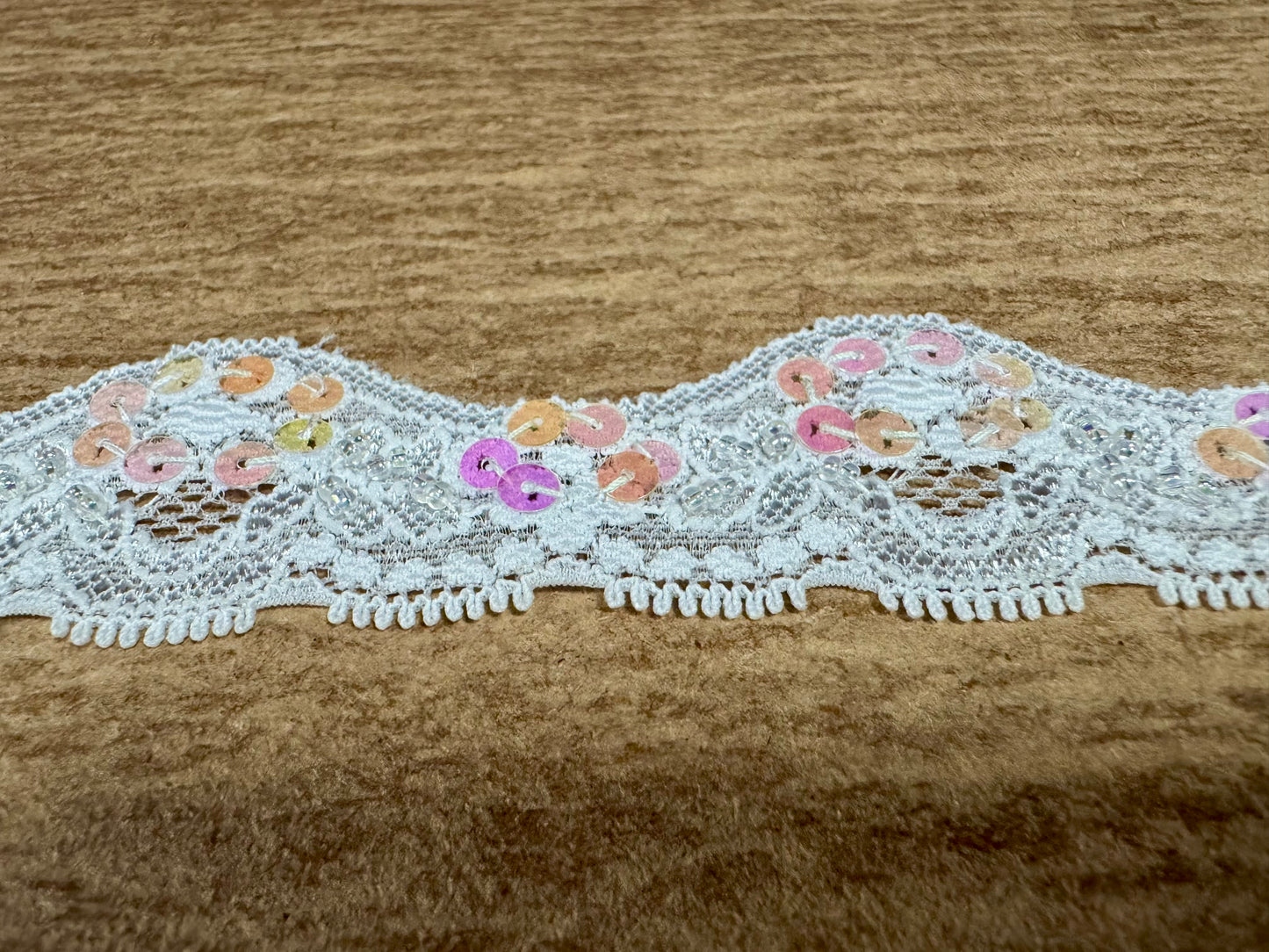 Scalloped lace edging trim fabric with sequins - stretch - paper white, pink & lilac