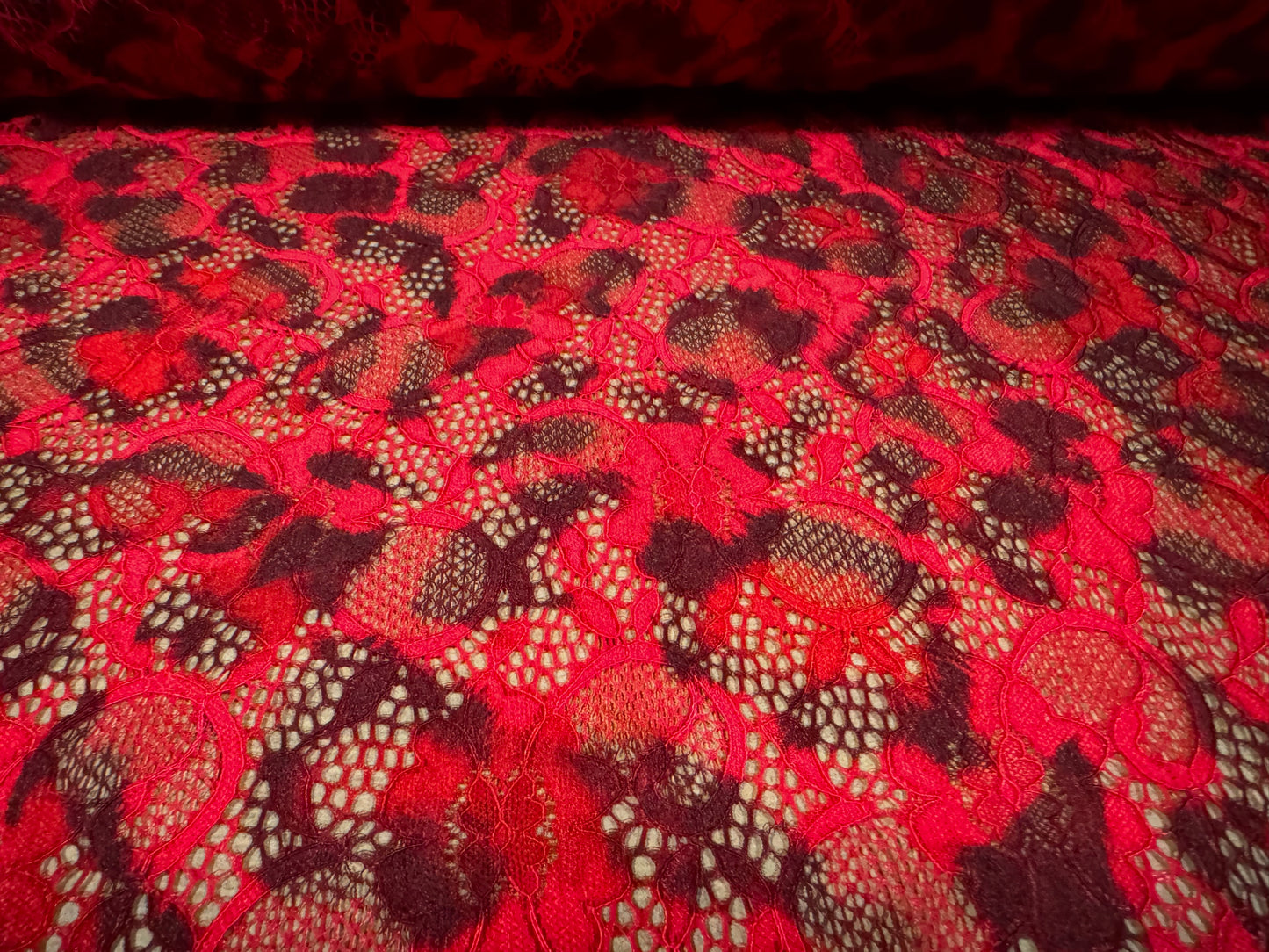 Stretch lace dress fabric with scalloped selvedge, per metre - leopard animal print - red & black