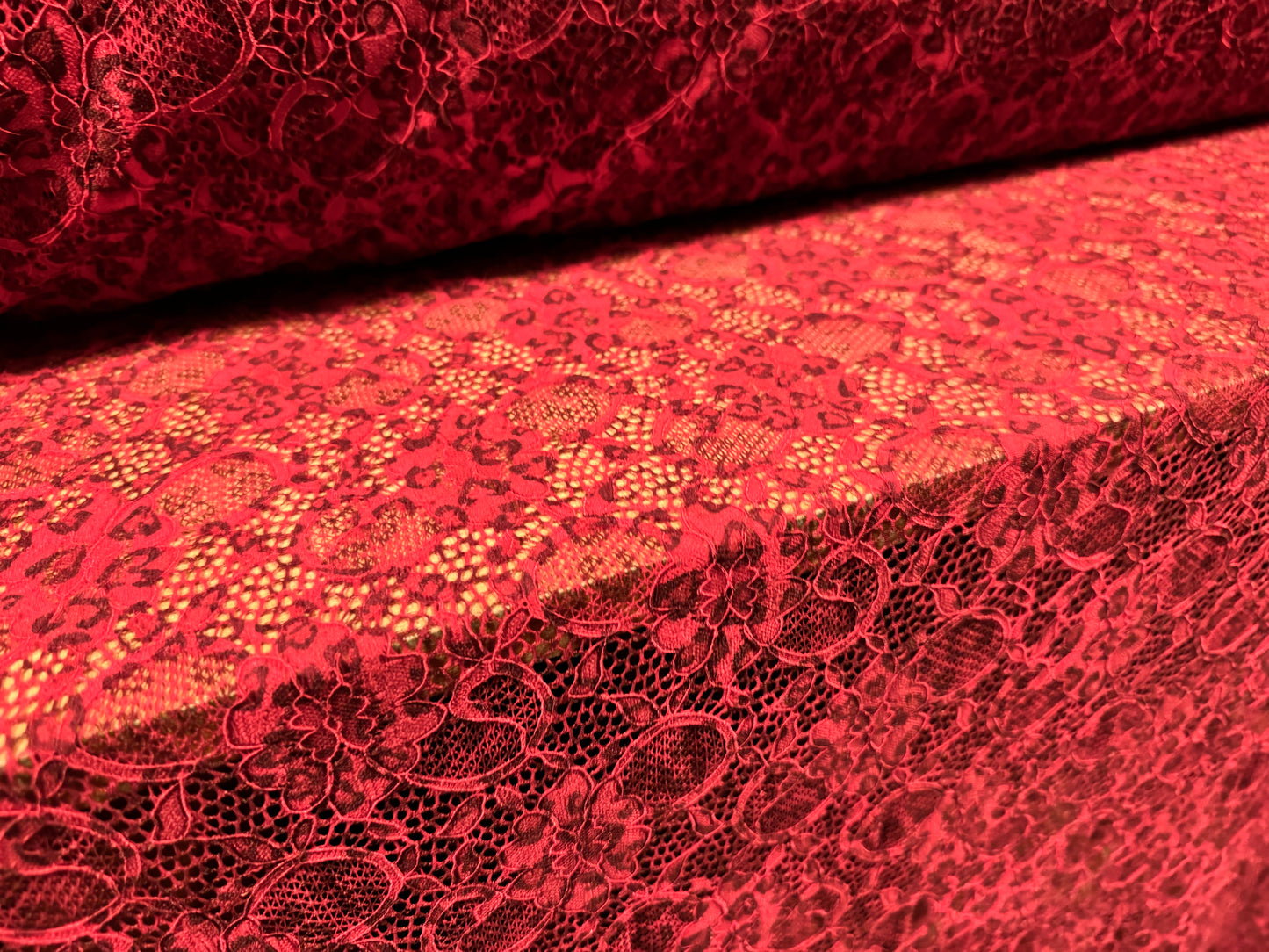 Stretch lace dress fabric with scalloped selvedge, per metre - animal print - red & black