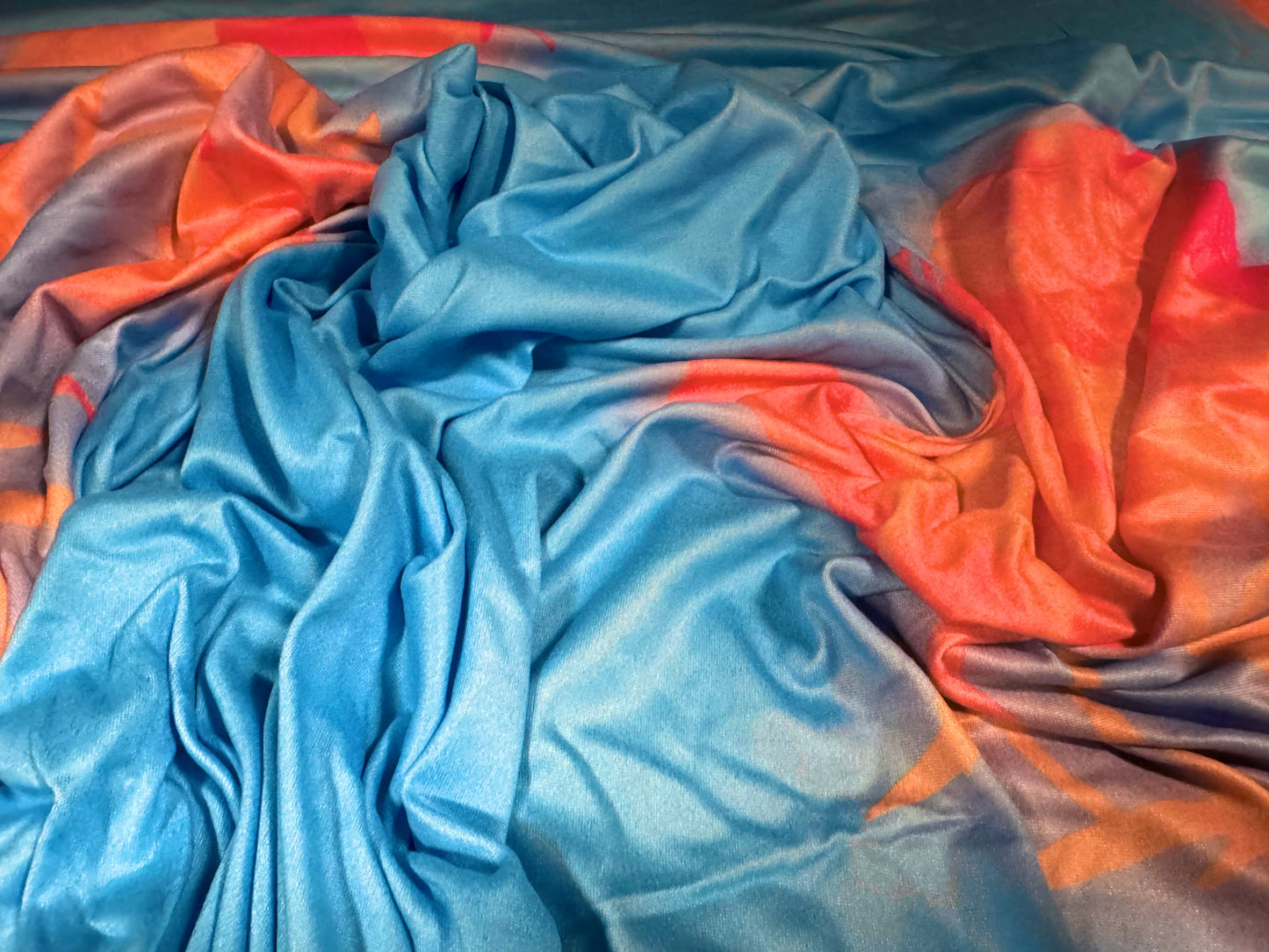 Soft touch stretch spandex single jersey fabric, per metre - stylised flower print - sky blue & orange