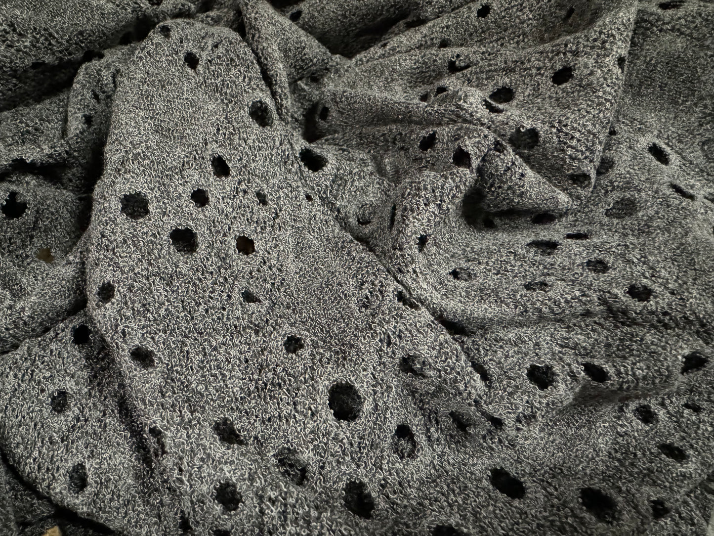 Eyelet jersey dress fabric, per metre - stylised flower - charcoal grey