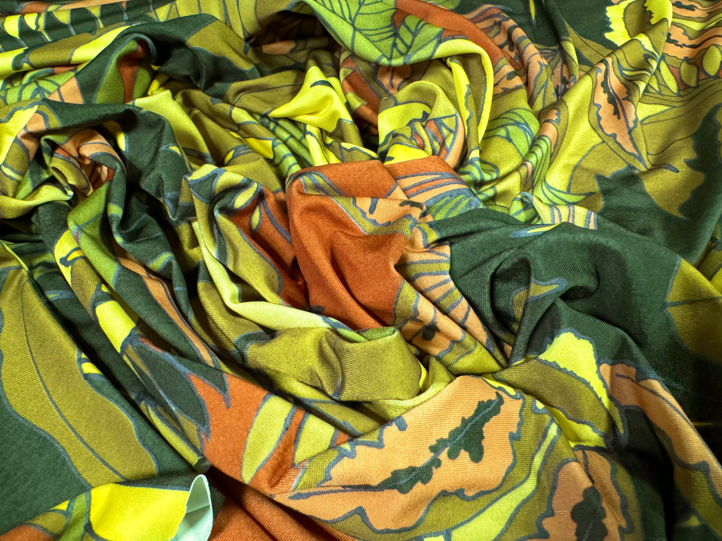 Soft touch stretch spandex single jersey fabric, per metre - jungle leaves print - green & rust